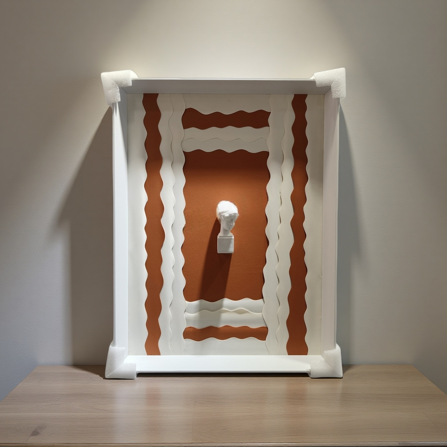 3D sculptural bust wall art with terracotta wave background and white frame – 50×70cm