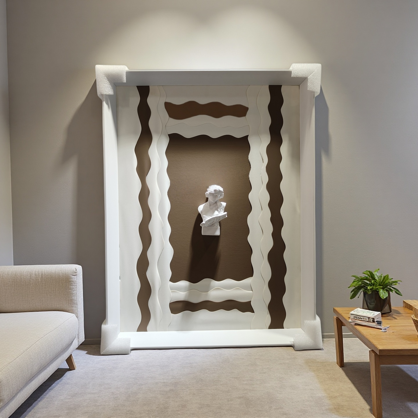 Minimalist wall art with wavy white frame and 3D plaster bust on taupe background
