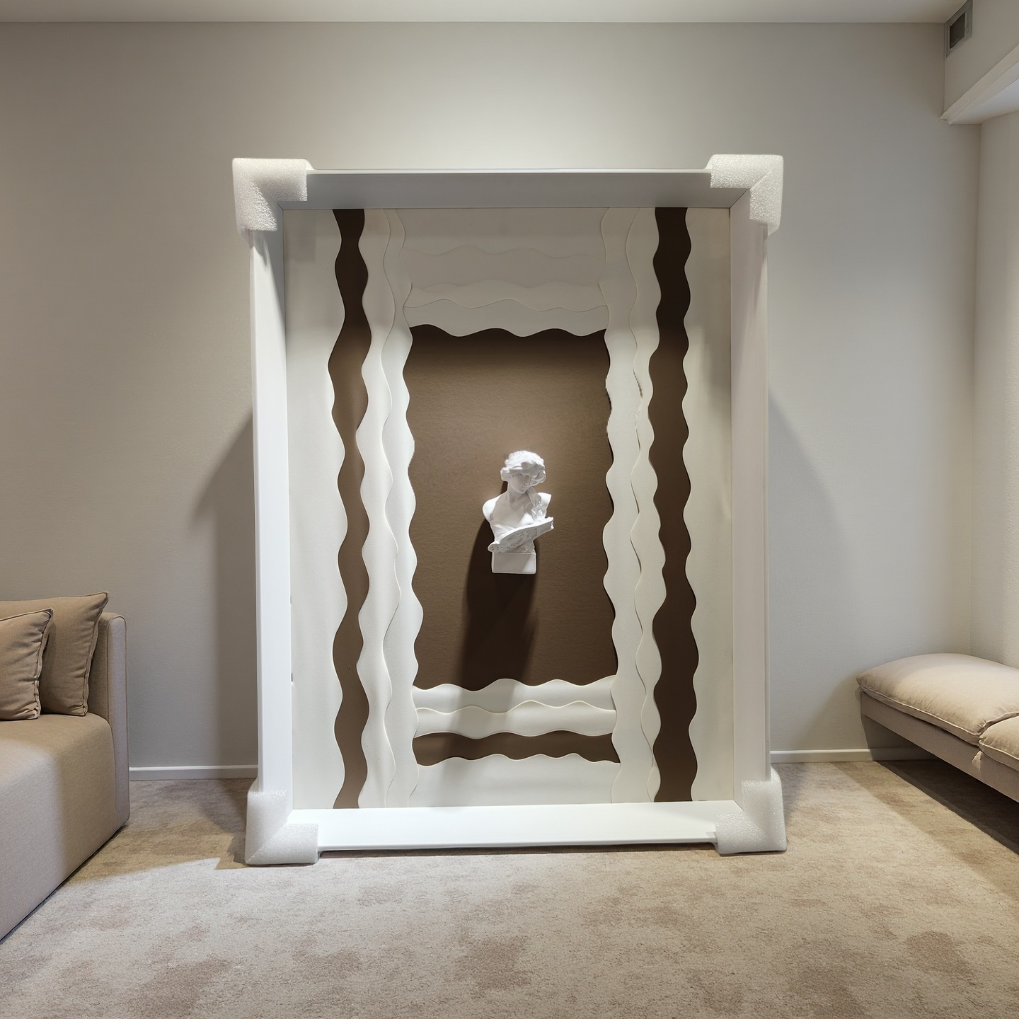 Minimalist wall art with wavy white frame and 3D plaster bust on taupe background