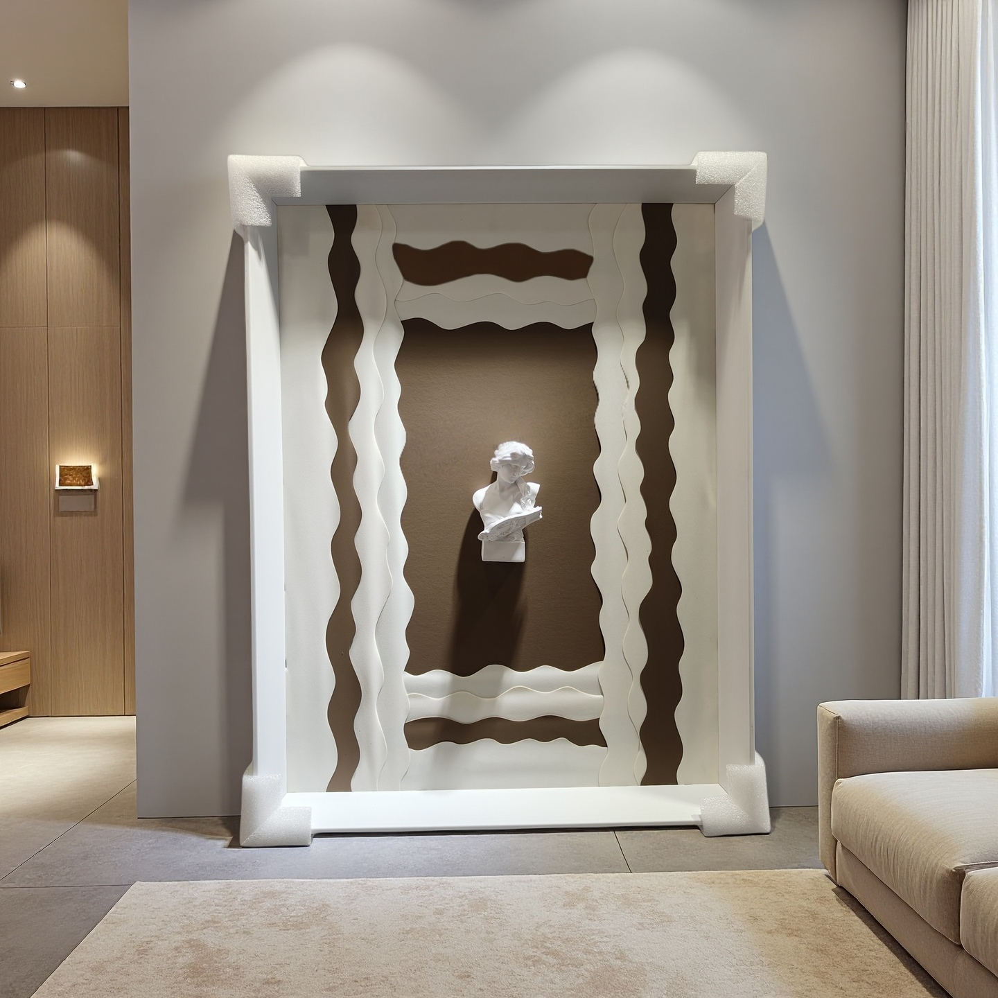 Minimalist wall art with wavy white frame and 3D plaster bust on taupe background

